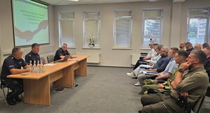 Policjanci i przedstawiciele podmiotów zewnętrznych podczas narady.