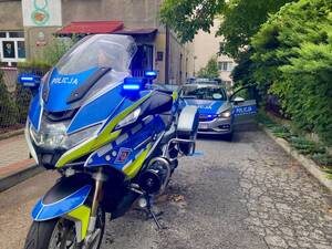 Motocykl służbowy i radiowóz na podjeździe Przedszkola.